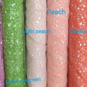 May include: Four rolls of sheer fabric with silver glitter stars printed on them. The fabric colors are lime green, light peach, peach, and orange.