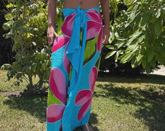 Falda pareo envolvente tropical con diseño hawaiano, color azul turquesa y multicolor, con flores de plumeria pintadas a mano