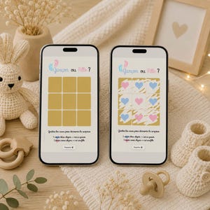 May include: Two smartphones showing a baby gender reveal game. One has blank squares, the other reveals blue and pink hearts. The text at the top says "Garçon ou Fille?" with instructions below. A knitted bunny, baby booties, and a dummy are also visible.