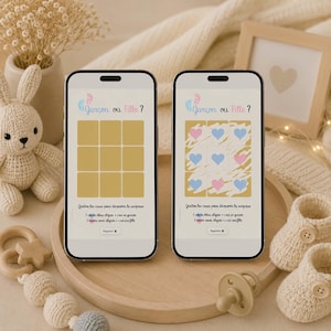 Può includere: Due smartphone mostrano un gioco di rivelazione del sesso con il testo "Garçon ou Fille?" in francese. Uno schermo mostra quadrati vuoti, l'altro rivela cuori blu e rosa. La scena include scarpine, un ciuccio e un vassoio di legno.