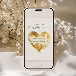 May include: A smartphone screen displays a digital card with French text and a golden heart. The text reads "Parce que tu comptes pour moi" and "Veux-tu être ma Demoiselle d'honneur?" A button at the bottom says "Regratter."