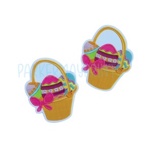 May include: Two yellow baskets filled with colorful Easter eggs. The baskets have a pink bow and a blue and green striped pattern.