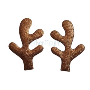 May include: A pair of brown glitter reindeer antlers. The antlers are made of felt and have a sparkly finish.