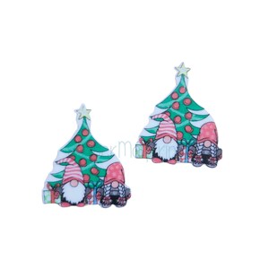 May include: Two gnomes stand in front of a green Christmas tree with red ornaments. They are holding presents and wearing red and white hats.