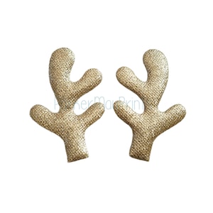 May include: A pair of gold glitter reindeer antlers. The antlers are made of felt and have a sparkly finish.