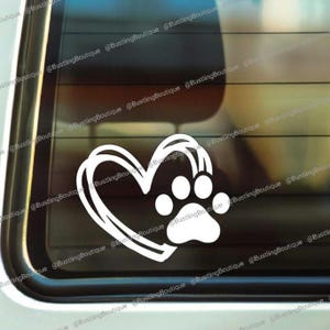 May include: White vinyl decal of a paw print inside a heart. The heart is outlined with a double line.