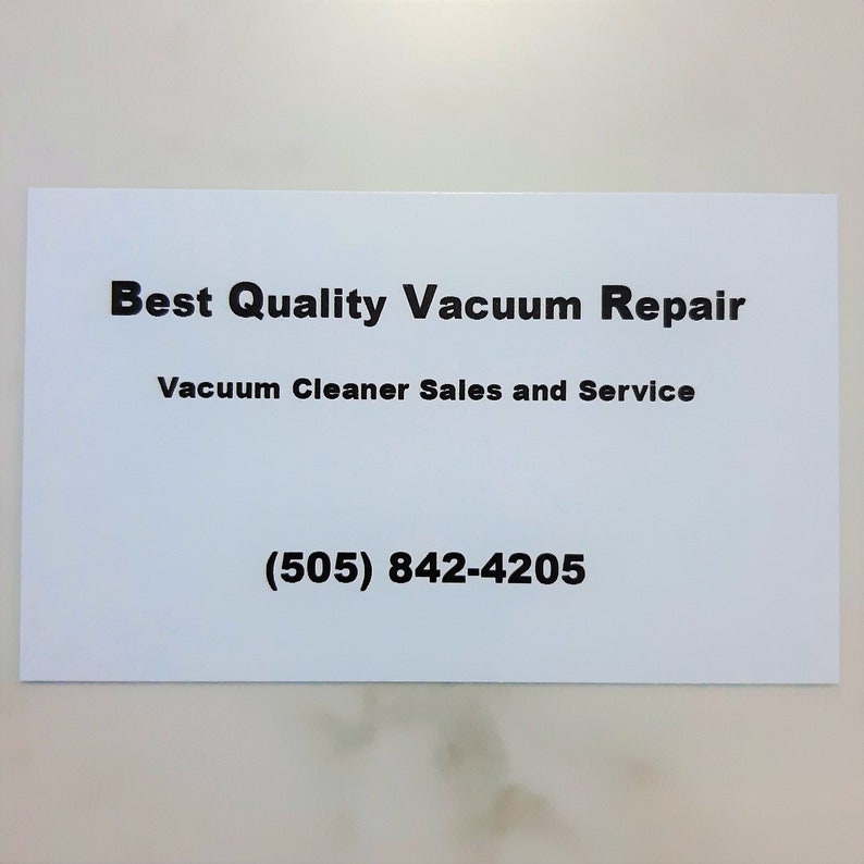 May include: White business card with black text that reads "Best Quality Vacuum Repair" and "Vacuum Cleaner Sales and Service" with the phone number (505) 842-4205.