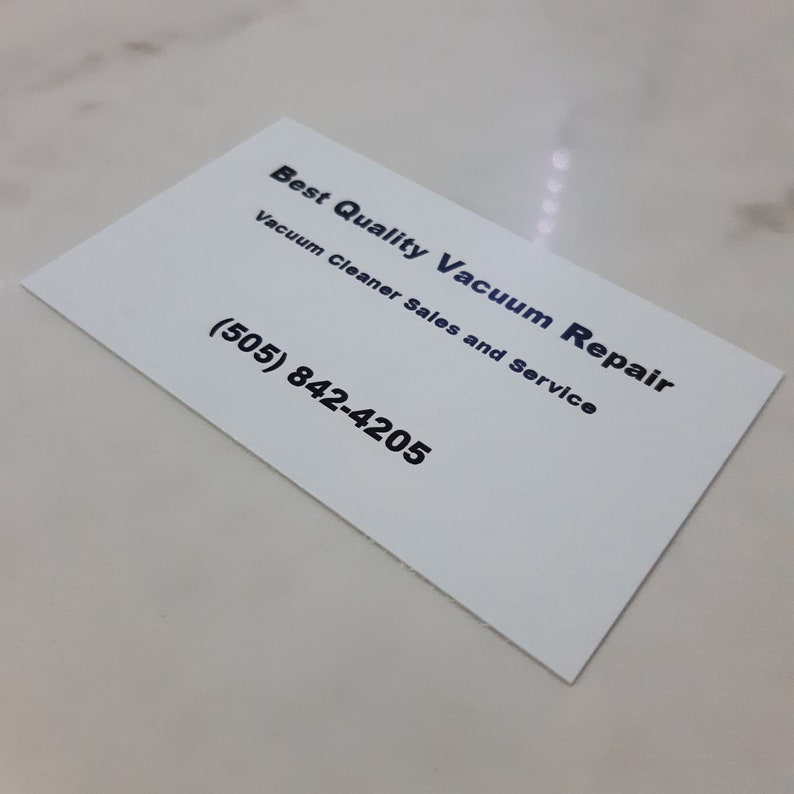 May include: White business card with black text that reads "Best Quality Vacuum Repair" and "Vacuum Cleaner Sales and Service". The phone number (505) 842-4205 is printed below the text.