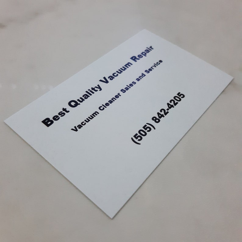 May include: White business card with black text that reads "Best Quality Vacuum Repair" and "Vacuum Cleaner Sales and Service". The phone number (505) 842-4205 is printed in black.