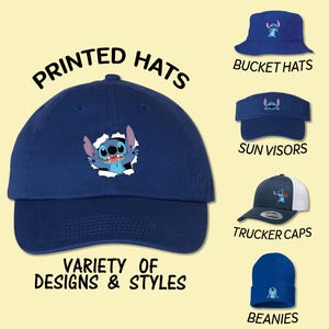 May include: Navy blue baseball cap with a Stitch graphic, alongside images of bucket hats, sun visors, trucker caps, and beanies. Text reads "Printed Hats" and "Variety of Designs & Styles."