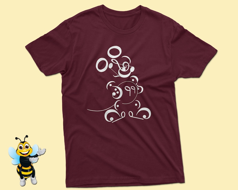 May include: Burgundy t-shirt with a white design of a cartoon character made of musical notes.