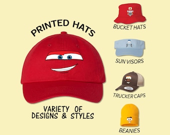 May include: A red baseball cap featuring a cartoon car face with blue eyes and a white smile. The text PRINTED HATS and VARIETY OF DESIGNS & STYLES appears alongside smaller images of a red bucket hat, light blue sun visor, brown trucker cap, and yellow beanie.