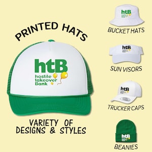 May include: A variety of printed hats with the logo "htB hostile takeover Bank" in green and yellow. The hats include trucker caps, bucket hats, sun visors, and beanies.