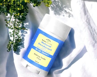 Może przedstawiać: Niebieski i żółty dezodorant w sztyfcie z etykietą "Ronner Natural Natural Deodorant with Mandelic Acid BLUE TANSY Baking Soda Free 2.5 oz"
