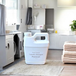 May include: A white plastic jug of laundry detergent with a label that reads "Roses Natural Laundry Detergent Patchouli".