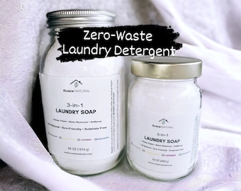 Op de afbeelding: Twee glazen potten met witte wasmiddel en gouden deksels. De grotere pot is gelabeld "Roses Natural 3-in-1 Wasmiddelzeep" en is 64 oz (1814 g). De kleinere pot is gelabeld "Roses Natural 3-in-1 Wasmiddelzeep" en is 16 oz (454 g). Beide potten hebben een wit etiket met zwarte tekst. De tekst "Zero-Waste Wasmiddel" is in zwart op een witte achtergrond boven de potten geschreven.