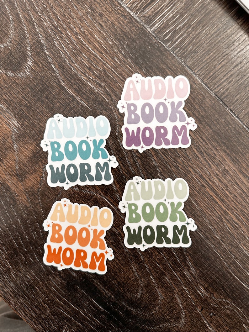 May include: Four colorful stickers with the text "Audio Book Worm" in a retro font. Each sticker has a different color scheme, with shades of pink, purple, blue, green, and orange.