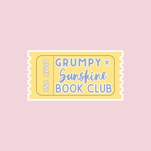 May include: A yellow ticket with a white border and the text "GRUMPY x Sunshine BOOK CLUB" in blue and black lettering. The ticket also says "ADMIT ONE" on the left side.