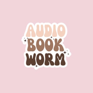 May include: A sticker with the text "AUDIO BOOK WORM" in a retro font. The words are in different shades of brown and beige, with white outlines. There are small white stars around the text.