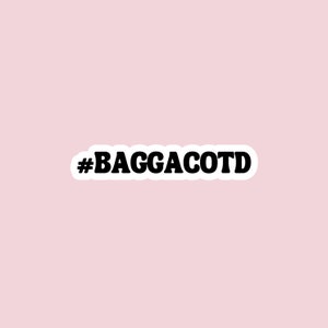 May include: Black and white sticker with the text "#BAGGACOTD" in a bold, retro font.
