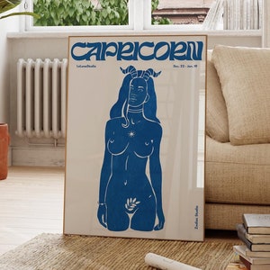 May include: Capricorn zodiac poster featuring a blue illustration of a woman with horns. The text on the poster says 'Capricorn' in a stylized font, along with the dates 'Dec. 22 - Jan. 19' and the names 'LeLunaStudio' and 'Zodiac Studio'. The poster has a minimalist design with a light beige background.