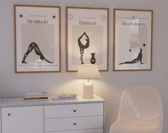 May include: Three framed prints with a minimalist design featuring yoga poses and the words "Gratitude", "Balance", and "Mindfulness".