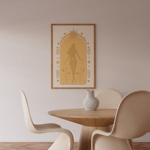 May include: A framed wall art print featuring a mustard yellow archway design with a central silhouette of a person, surrounded by celestial sun, star, and botanical motifs. The artwork is displayed in a light wood frame on a plain wall.
