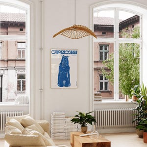 May include: A blue and white poster with the word "Capricorn" in bold, stylized letters. The poster features a blue silhouette of a woman with a crown of flowers on her head.