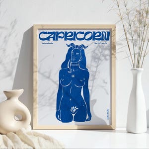 May include: A blue and white print of a Capricorn zodiac sign. The image features a woman with horns and a star on her chest. The text "Capricorn" is in a bold, stylized font. The text "Dec. 22 - Jan. 19" is also included.