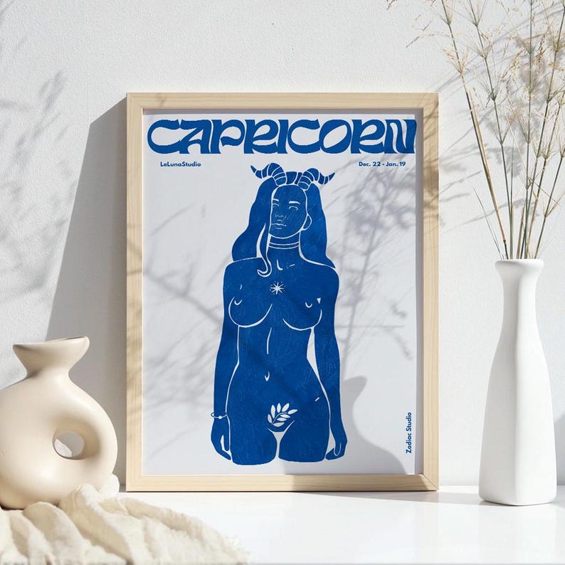 May include: A blue and white print of a Capricorn zodiac sign. The image features a woman with horns and a star on her chest. The text "Capricorn" is in a bold, stylized font. The text "Dec. 22 - Jan. 19" is also included.