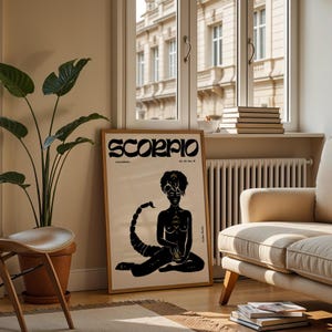 May include: A black and white poster with the word "Scorpio" in a stylized font. The poster features a black silhouette of a woman with a scorpion tail, sitting with her legs crossed. The poster has a cream background.