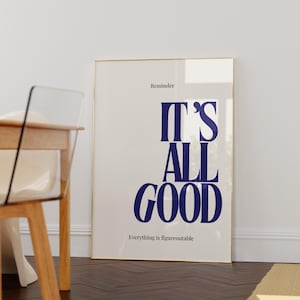 Può includere: Una stampa artistica da parete rettangolare in una sottile cornice dorata con sfondo bianco e tipografia blu scuro. Il testo recita "Reminder", "IT'S ALL GOOD" e "Everything is figureoutable" in un carattere sans-serif moderno e pulito.