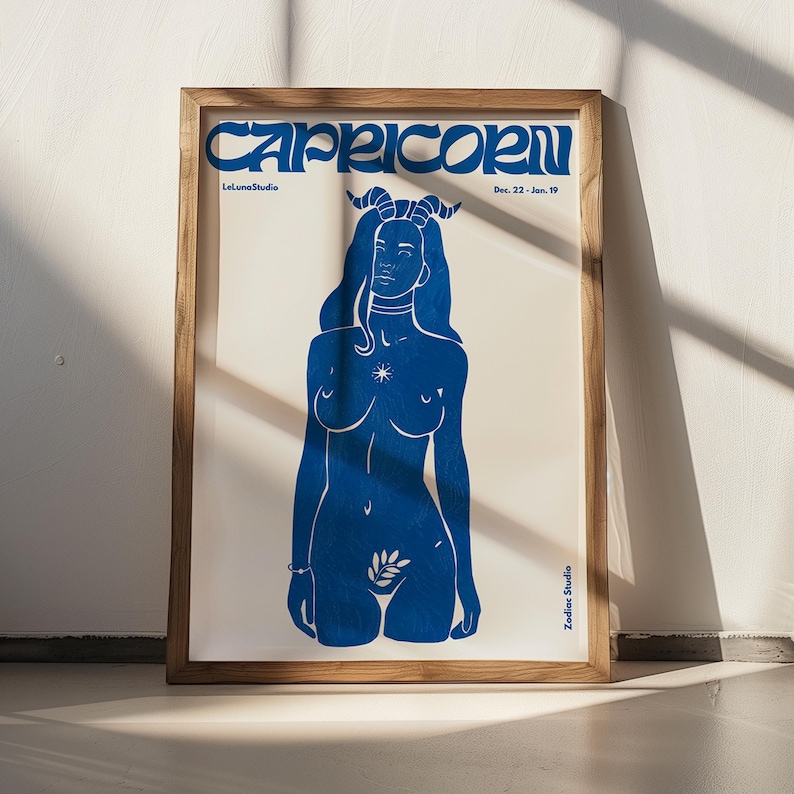 May include: A blue and white poster with the text "Capricorn" in a stylized font. The poster features a blue silhouette of a woman with horns, a star, and a leaf.