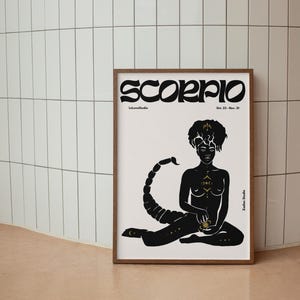 May include: A black and white illustration of a Scorpio zodiac sign. The illustration features a woman with a scorpion tail and gold accents. The text "Scorpio" is written in a bold, stylized font at the top of the image. The dates "Oct. 23 - Nov. 21" are written below the title.