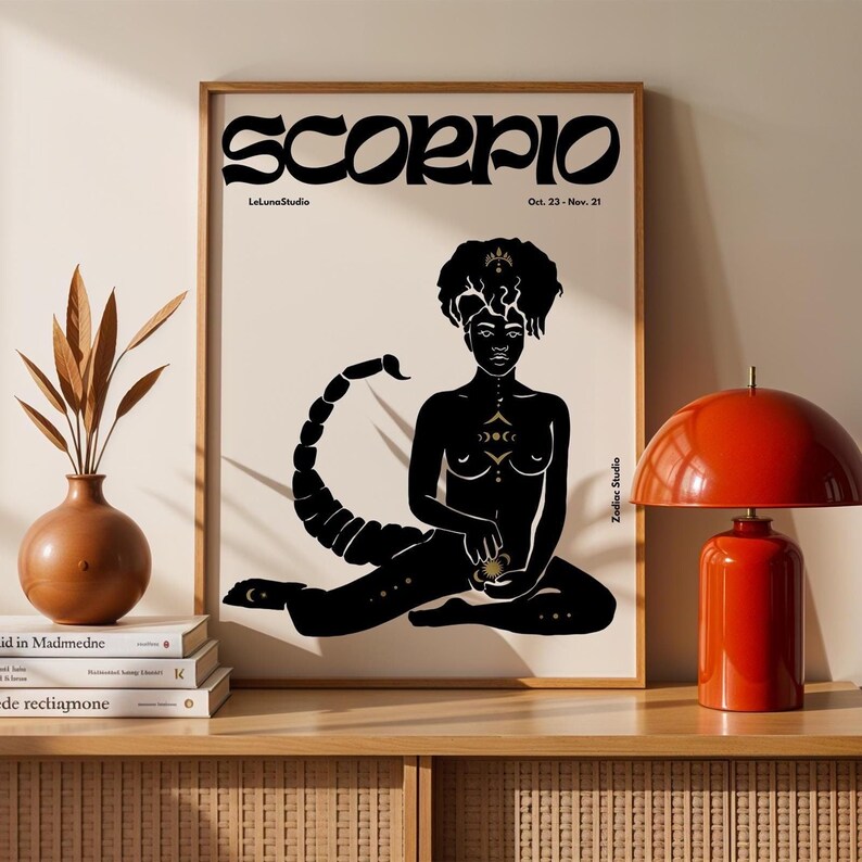 May include: Black and gold print of a Scorpio zodiac sign with a woman sitting with a scorpion tail. The text "SCORPIO" is in bold, black letters with a gold outline. The text "LeLunaStudio" and "Zodiac Studio" are in smaller, gold letters. The text "Oct. 23 - Nov. 21" is in smaller, black letters.