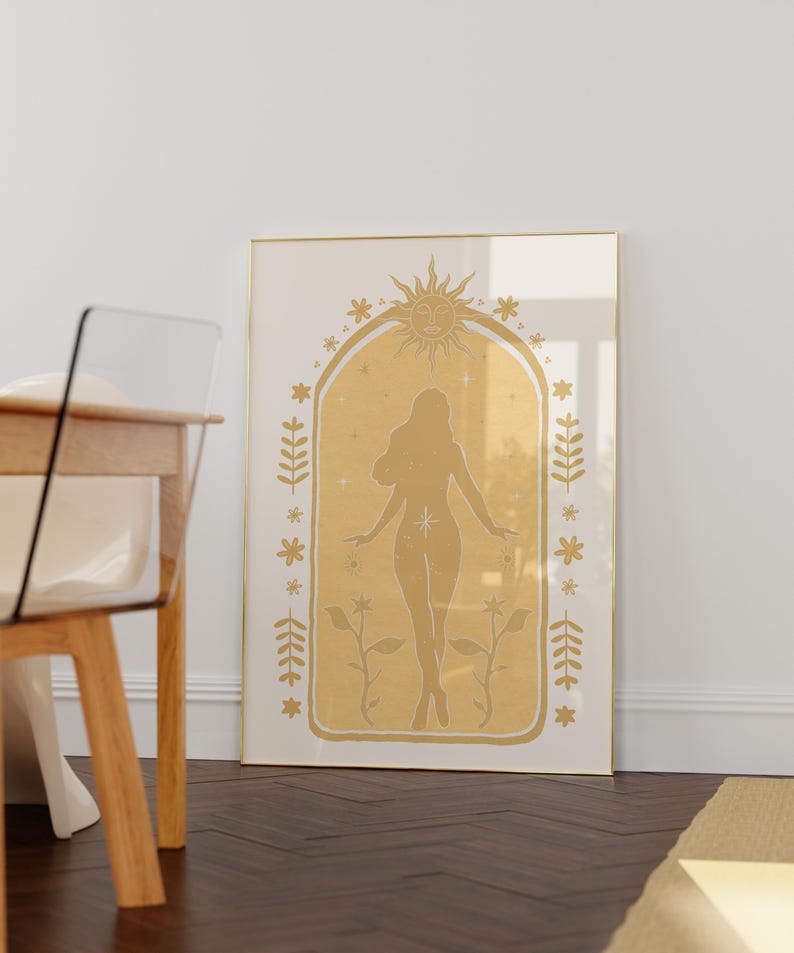 May include: A framed wall art print featuring a gold-toned illustration of a human silhouette centered within an arched frame. The design includes a sun motif at the top, surrounded by small stars, floral elements, and leafy branches on both sides.