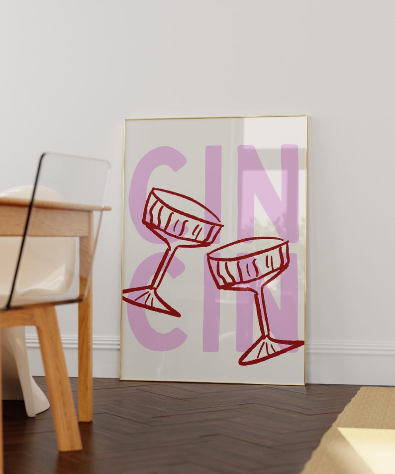 Puede incluir: Una impresi&oacute;n art&iacute;stica enmarcada con la palabra "GIN" en letras grandes de color lila. Dos copas de vino rojas est&aacute;n dibujadas en un estilo simple e ilustrativo. El fondo es de color crema claro.