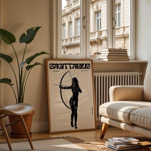 May include: A black and white poster with the word "Sagittarius" in a retro font. The poster features a silhouette of a woman holding a bow and arrow.