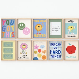 May include: A collection of framed art prints with positive messages and whimsical illustrations. The prints feature phrases like "You Got This," "Your Ideas Matter," and "You Can Do Hard Things!" along with smiley faces, flowers, and an apple.