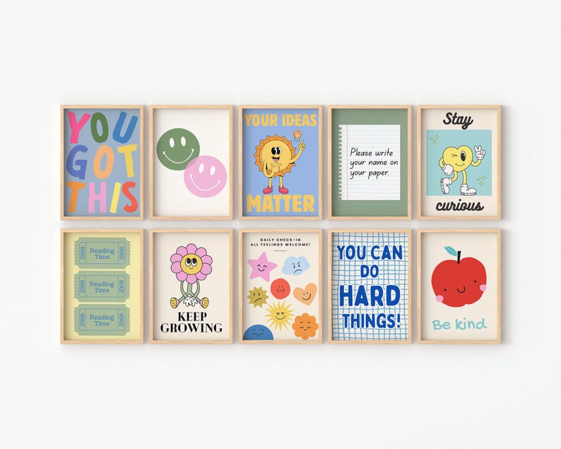 May include: A collection of framed art prints with positive messages and whimsical illustrations. The prints feature phrases like "You Got This," "Your Ideas Matter," and "You Can Do Hard Things!" along with smiley faces, flowers, and an apple.