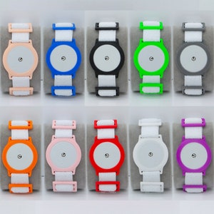 May include: Ten colorful wristbands with a round white button in the center. The wristbands are made of a soft, flexible material and are available in a variety of colors, including orange, pink, red, white, blue, green, purple, and gray.