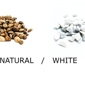 May include: Two piles of decorative stones, one pile of natural brown and white stones, and one pile of white stones. The text "NATURAL / WHITE" is below the piles of stones.