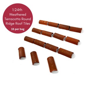 May include: 1:24th scale weathered terracotta round ridge roof tiles. There are 15 tiles in a bag. The tiles are a reddish brown colour and have a textured surface.