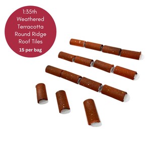 May include: 1:35th scale weathered terracotta round ridge roof tiles. There are 15 tiles in a bag. The tiles are brown with a speckled texture.