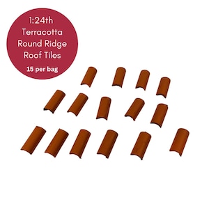 May include: 15 terracotta round ridge roof tiles in a 1:24 scale. The tiles are a reddish-brown color and are arranged in a scattered pattern on a white background.