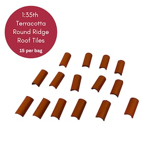 May include: 1:35th scale terracotta round ridge roof tiles. There are 15 tiles in a bag. The tiles are a reddish-brown colour.