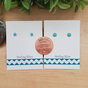 May include: Two pairs of turquoise earrings on white cards with the text "Sterling Silver". A US penny is placed next to the earrings on the right card for size comparison.