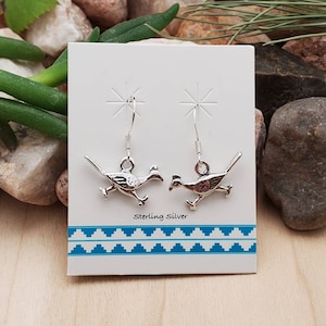 May include: Sterling silver earrings featuring a pair of running roadrunner birds. The earrings are on a white card with the text "Sterling Silver".