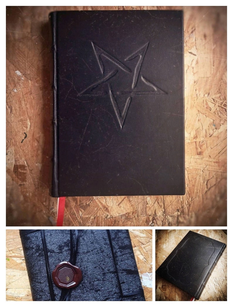 May include: A black leather-bound journal with a five-pointed star embossed on the front cover. The journal has a red ribbon bookmark and a wax seal on the spine.