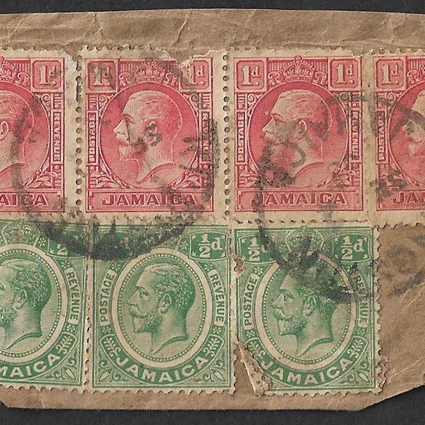 1935 Jamaica King George V 0.5d green stamps x 3 and 1d definitive red stamps x 4 used on small piece